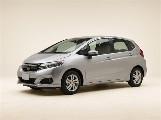 Silver Honda Fit hatchback photographed in a studio
