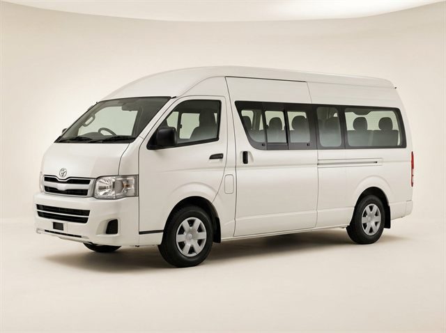 White Toyota Hiace high-roof minibus photographed in a studio